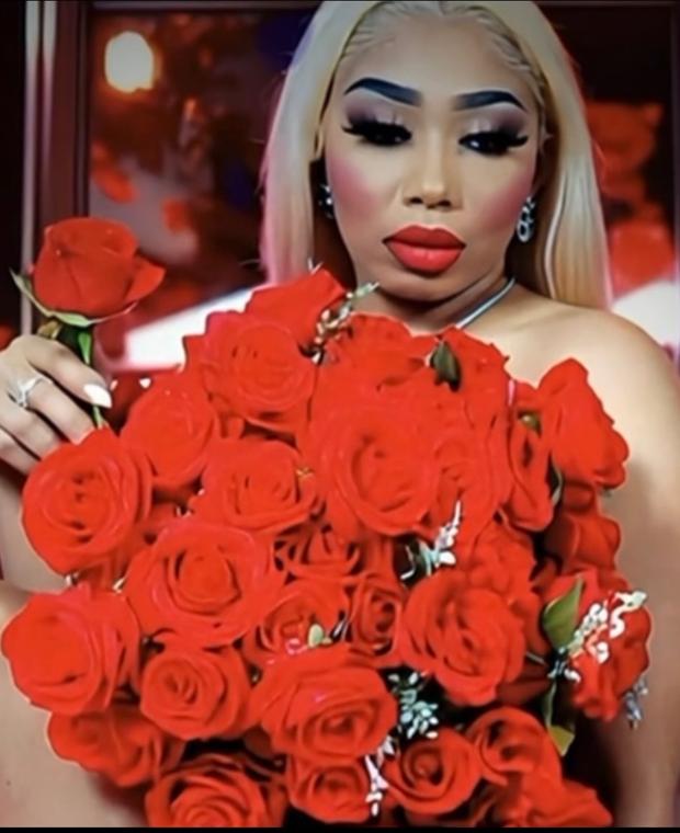 The founder and CEO of Blush Nail Studio holding a bouquet of red roses